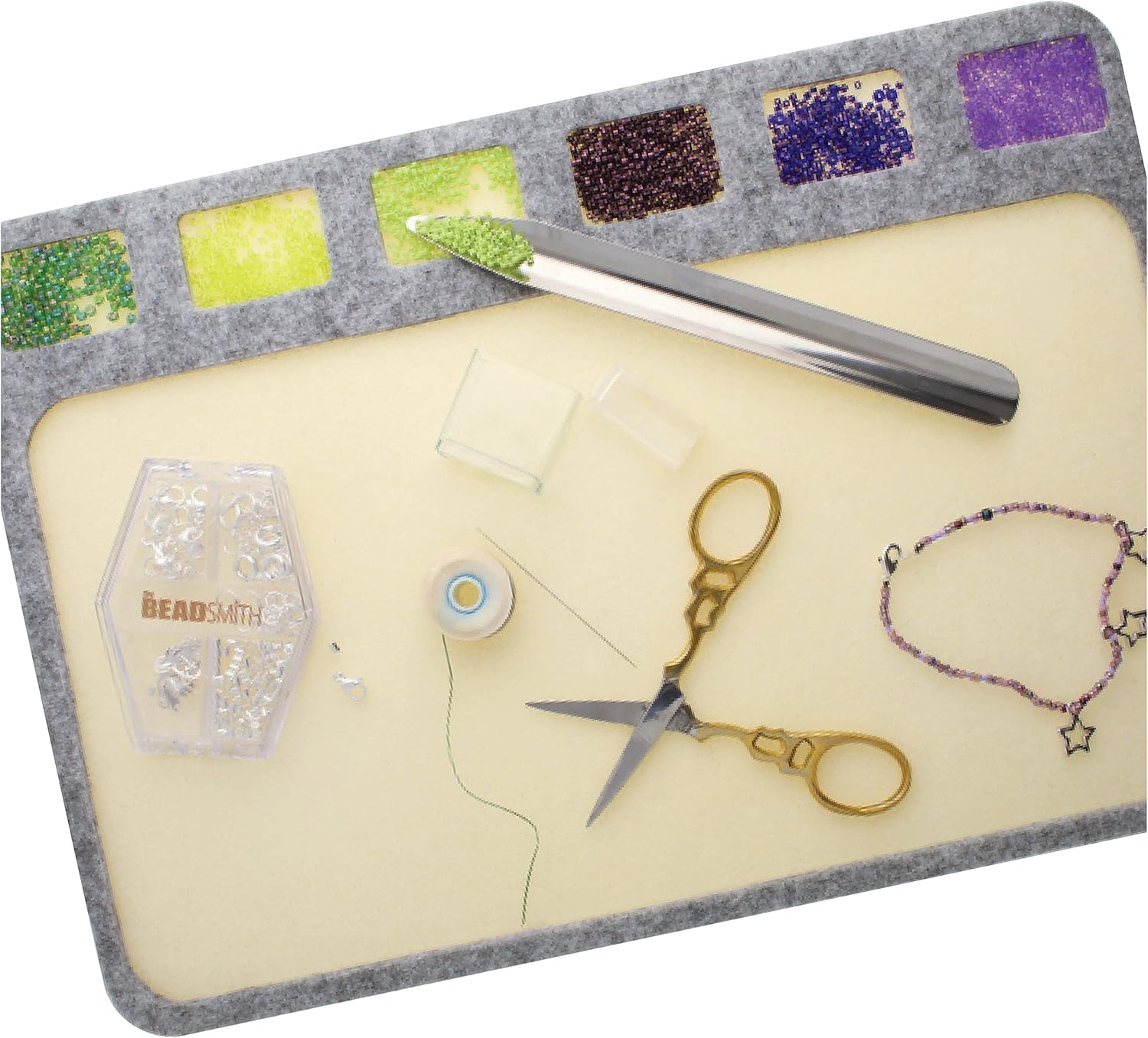BeadSmith bead board with beads, scissors, tool, thread, and clasps for jewelry making.