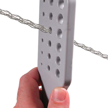 Hand using gray wire rope diameter gauge to measure a wire rope sling.