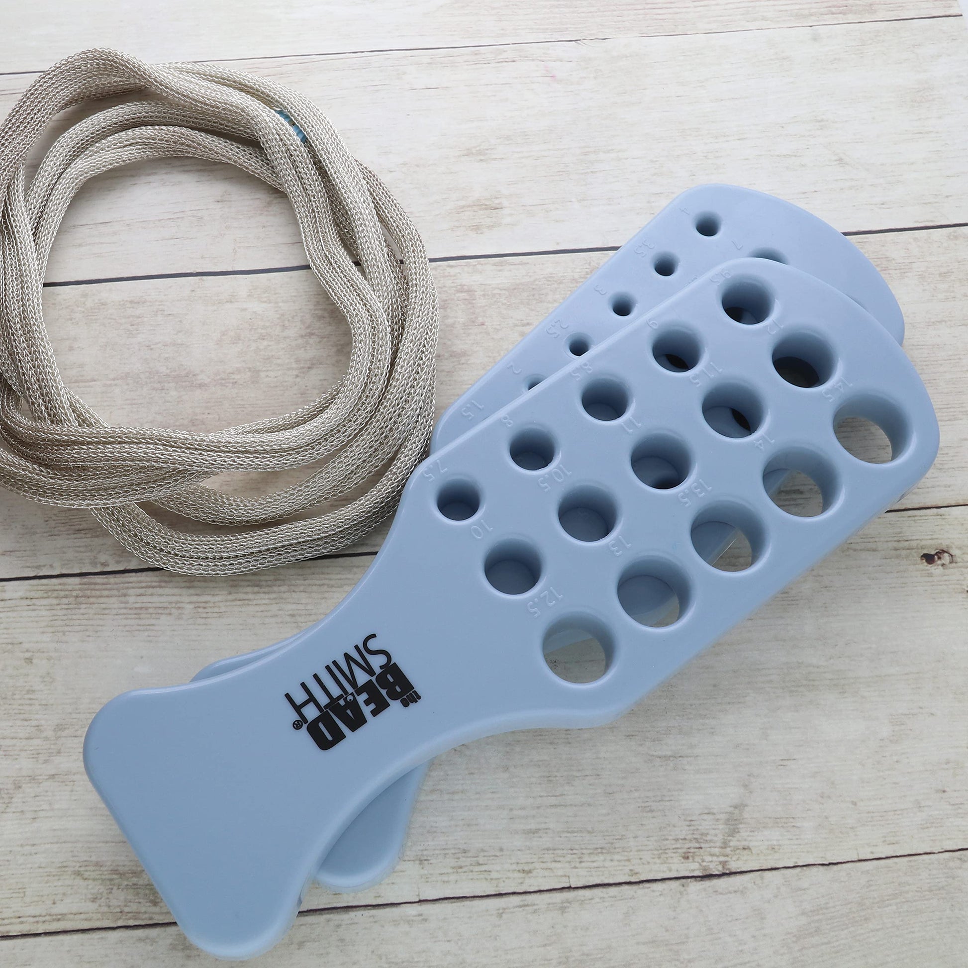 Beadsmith metal mesh and blue multi-hole draw plate for jewelry making, showing various hole sizes.